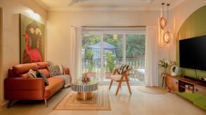 a living room with a couch and a tv at Casa Superfly 2BHK with Rooftop Jacuzzi & Terrace Deck Excellent Location Boilermaker Thalassa in Oxel