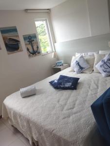 a bedroom with a large white bed with a window at Flat Porto Marina Mont Blanc in Mangaratiba +31 photos