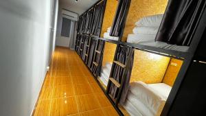 a row of bunk beds in a room at Softbox Hostel in Ban Laem Thong Lang