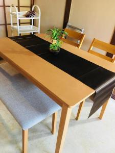 a wooden table with a plant on top of it at 山下ビル403 in Kitakyushu