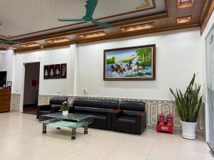a waiting room with a couch and a table at Galaxy Airport Hotel in Hanoi