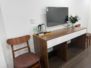 a desk with a television on top of it at Galaxy Airport Hotel in Hanoi