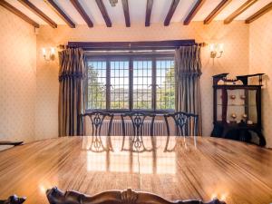 a dining room with a table and a window at High Biggin in Windermere +25 photos