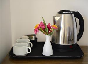a coffee maker and a vase of flowers on a tray at The bubble camp in Wadi Rum