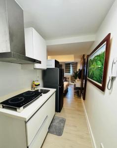 a kitchen with a stove and a refrigerator at Mekeni Azure Escape in San Fernando