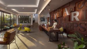 a woman sitting at a desk in a lobby at Grand Yard La Residence in Siem Reap