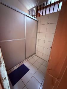 a bathroom with a shower stall with a blue mat at Cabaña Gerya in Chachagua +14 photos