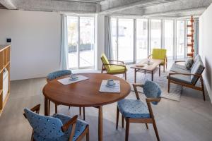 a dining room with a table and chairs at まえばしガレリアArt residence & Hotel in Maebashi