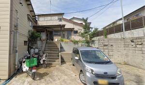 a car parked in front of a house at Bushido Kashiwa in Kashiwa