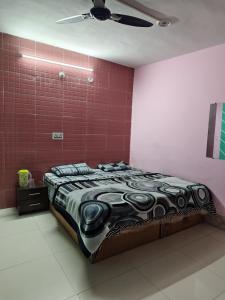 a bed in a room with a red wall at ONLY CAFE Hotel in Chopta