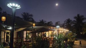 a street light in front of a building at night at Mook Raya Resort in Ko Mook +29 photos