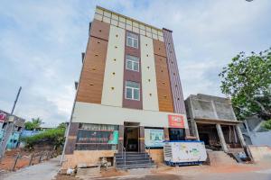 a tall building with stairs in front of it at Right choice hotels in Rāmeswaram