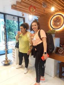 two women standing next to each other holding wine glasses at J7 Villaj Resort in Trincomalee +117 photos