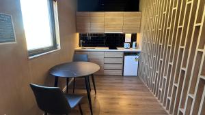 a small kitchen with a small table and chairs at Guide Hill Station Lodge in Lake Tekapo +18 photos