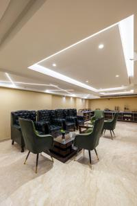 a conference room with chairs and a couch and a table at The Vanson Delite "Newly Rebuilt 2026" - Near New Delhi Station & Connaught Place in New Delhi