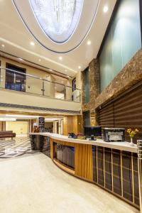 an office lobby with a large circular ceiling at The Vanson Delite "Newly Rebuilt 2026" - Near New Delhi Station & Connaught Place in New Delhi