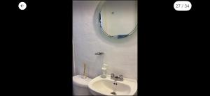a bathroom with a sink and a mirror and a toilet at Cómoda y céntrica habitación en Tenochtitlán, en departamento compartido, CDMX in Mexico City +14 photos