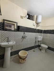 a bathroom with a sink and a toilet at ONLY CAFE Hotel in Chopta