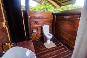 a bathroom with a toilet and a sink at Raintree Haven in Dambulla
