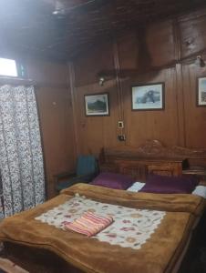 a bedroom with two beds on a boat at Goona residence in Srinagar +4 photos