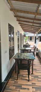 a row of tables and chairs on a patio at Nilaveli Beach Rooms in Nilaveli