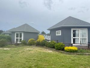 a house with a yard in front of it at Pineacres Motel and Park in Kaiapoi