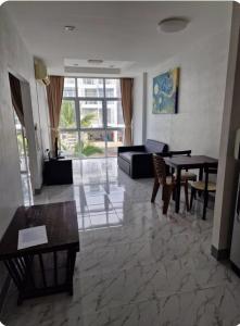 a living room with a couch and a table at Eid and Philippe's Home building A9 in Ban Ko Kwang