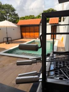 a grill with a view of a swimming pool at Espaço prime piscina aquecida in Sorocaba