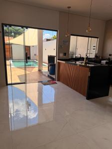 a living room with a kitchen and an open floor plan at Espaço prime piscina aquecida in Sorocaba