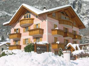 a building with snow in front of it at Residence Rio Piccolo in Molveno