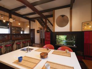 ein Esszimmer mit einem Tisch und roten Stühlen in der Unterkunft いけだ屋 in Kōzai