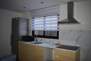 a kitchen with a sink and a refrigerator and a window at Apartamento Casa Leo in Playa Blanca +23 photos
