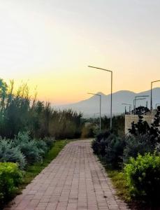 a brick road with street lights in the distance at La casa de Alex in San Juan Opico