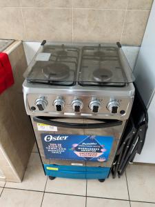 a gas stove with a box in a kitchen at La casa de Alex in San Juan Opico +19 photos