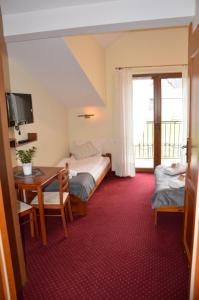 Ένα ή περισσότερα κρεβάτια σε δωμάτιο στο Willa Trybszanka