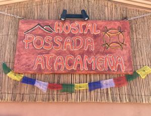 a sign for aossanian restaurant at americana at Posada Atacameña in San Pedro de Atacama