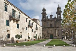 a building with a courtyard with white balls on the ground at Hospederia Monasterio de Poio in Poio