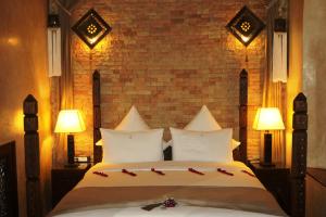 Кровать или кровати в номере Riad Kalaa