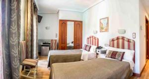 Postel nebo postele na pokoji v ubytování Hotel Tibur