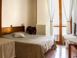 Postel nebo postele na pokoji v ubytování Domus Hotel