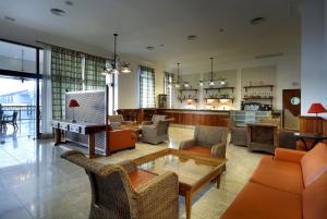 a living room with couches and chairs and a table at Grand Palladium Imbassaí Resort & Spa - All Inclusive in Imbassai