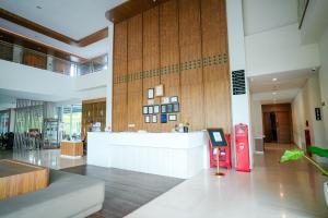 a lobby with a counter in the middle of a building at Patra Dumai Hotel in Dumai +74 photos