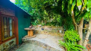 a garden with a bird bath next to a house at Yala Savanna Leopard Lodge in Hambantota