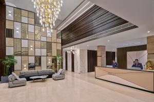a lobby with a reception desk in a building at Varay Grande in Ujjain