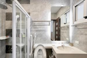 a bathroom with a sink and a toilet and a mirror at 芙蘿拉萃旅 in Taitung City +33 photos
