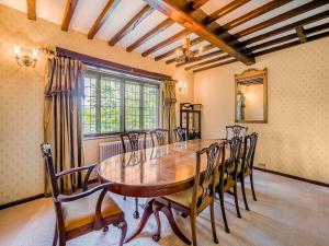 a dining room with a wooden table and chairs at High Biggin in Windermere