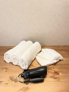 a hair dryer and a towel on a wooden floor with a blow dryer at TIC HOTEL Hisayaodorisakae in Nagoya