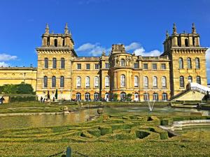a large building with a pond in front of it at Moon House in Oxford