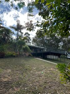 a building with a bridge in the middle of a park at The Haven House in Singleton
