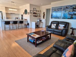 a living room with a couch and a table at Whaler's Cove in Portland +44 photos